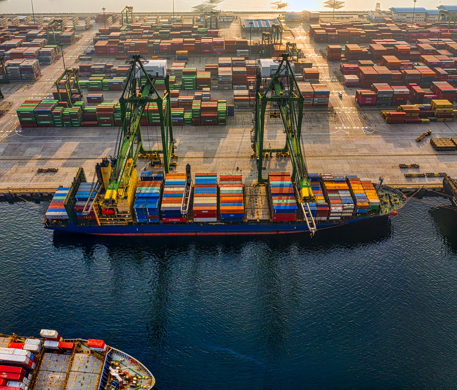 Aerial shot of colorful shipping containers at North Jakarta's bustling port, Indonesia.